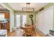 Dining room with light green walls, wooden table, and a modern light fixture at 550 Stateline Rd, Bowdon, GA 30108