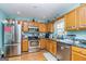 Well-equipped kitchen featuring stainless steel appliances, wood cabinets, and ample counter space at 550 Stateline Rd, Bowdon, GA 30108