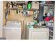 Functional laundry room with washer, dryer, and plenty of shelving at 550 Stateline Rd, Bowdon, GA 30108