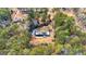 Aerial view of a charming single-story home nestled among mature trees with a lightly snow-dusted roof at 160 Pine Trail Rd, Fayetteville, GA 30214