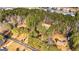 Aerial view of a home with mature trees and an extra long driveway and nearby business at 160 Pine Trail Rd, Fayetteville, GA 30214