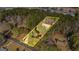 Aerial view of property with yellow property lines amongst a wooded setting at 160 Pine Trail Rd, Fayetteville, GA 30214