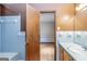 Bathroom with blue tiles on the wall, vanity, bathtub, and doorway to the bedroom at 160 Pine Trail Rd, Fayetteville, GA 30214