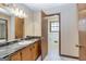 Bathroom featuring a vanity, a marble countertop, mirror, and a door opening to a second bath at 160 Pine Trail Rd, Fayetteville, GA 30214