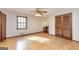 Large bedroom featuring hardwood floors, ceiling fan, and built in vanity at 160 Pine Trail Rd, Fayetteville, GA 30214