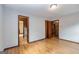 Bedroom with hardwood floors, neutral walls, and view into the bathroom and closet at 160 Pine Trail Rd, Fayetteville, GA 30214
