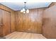 Quaint dining room features hardwood floors, chandelier lighting, and wood-paneled walls at 160 Pine Trail Rd, Fayetteville, GA 30214