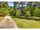 Long driveway leading to a private home surrounded by lush greenery and mature trees, creating a serene setting at 160 Pine Trail Rd, Fayetteville, GA 30214