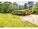 Well-maintained single-story home with a two-car garage, green lawn and partial deck at 160 Pine Trail Rd, Fayetteville, GA 30214