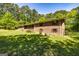 Well-maintained brick house with visible window shutters, set on a spacious lot with mature trees offering shade at 160 Pine Trail Rd, Fayetteville, GA 30214