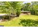 Single-story brick home on a well-manicured lawn, featuring mature trees that offer privacy and shade at 160 Pine Trail Rd, Fayetteville, GA 30214