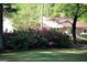 Manicured front lawn with colorful azaleas and greenery, showcasing the home's curb appeal at 160 Pine Trail Rd, Fayetteville, GA 30214