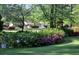 Well-manicured lawn with various flowering bushes in a neatly landscaped front yard, enhancing the home's appeal at 160 Pine Trail Rd, Fayetteville, GA 30214
