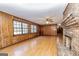 Comfortable living room with bright hardwood floors, wood-paneled walls, and large windows at 160 Pine Trail Rd, Fayetteville, GA 30214