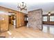 Wide-open living room featuring wood-paneled walls, hardwood floors, and pass-through to kitchen at 160 Pine Trail Rd, Fayetteville, GA 30214