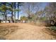 Large backyard with tall trees and a wooden fence at 1800 Stockton Walk Ln, Snellville, GA 30078