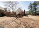 A backyard featuring a wooden fence with mature trees at 1800 Stockton Walk Ln, Snellville, GA 30078