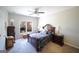 Cozy bedroom with a ceiling fan, a dark wood sleigh bed, and a view of the backyard at 1800 Stockton Walk Ln, Snellville, GA 30078