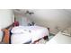 A secondary bedroom featuring sloped ceilings, ceiling fan, and neutral colored walls and carpet at 1800 Stockton Walk Ln, Snellville, GA 30078