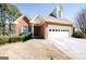 Beautiful brick home with a dormer window over the garage, attached garage and front yard at 1800 Stockton Walk Ln, Snellville, GA 30078