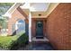Close-up of a brick home's entryway with a decorative wreath on the door at 1800 Stockton Walk Ln, Snellville, GA 30078