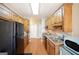 Galley kitchen with wooden cabinets and modern appliances at 1800 Stockton Walk Ln, Snellville, GA 30078