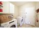 Efficient laundry room equipped with modern appliances and storage cabinets for convenience at 1800 Stockton Walk Ln, Snellville, GA 30078