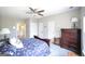 A bright main bedroom with a ceiling fan, a sleigh bed, and multiple closets for storage at 1800 Stockton Walk Ln, Snellville, GA 30078