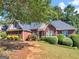 Beautiful single-Gathering home featuring brick exterior and lush green landscaping, creating a warm and inviting atmosphere at 925 Champions Way, Mcdonough, GA 30252