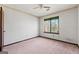 Neutral bedroom with a ceiling fan and a window providing natural light at 4847 Royal Dr, Duluth, GA 30096