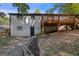 Spacious backyard featuring a two-story house, wooden deck, and concrete walkway at 859 Kings Grant Nw Dr, Atlanta, GA 30318