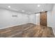 Spacious basement with wood-look tile flooring and a barn-style door at 859 Kings Grant Nw Dr, Atlanta, GA 30318