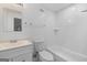 Well-lit bathroom showcases a white vanity, modern fixtures, and tiled shower and bathtub at 859 Kings Grant Nw Dr, Atlanta, GA 30318