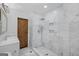 Updated shower with marble tiling and spa-like rainfall shower head at 859 Kings Grant Nw Dr, Atlanta, GA 30318