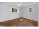 Bright bedroom with hardwood floors and natural light from two windows at 859 Kings Grant Nw Dr, Atlanta, GA 30318