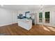 Modern kitchen featuring white cabinetry, stainless steel appliances, blue backsplash, and hardwood floors at 859 Kings Grant Nw Dr, Atlanta, GA 30318