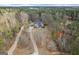 A high angle aerial view showcasing the house nestled within a forest landscape at 172 Sam Solomon Rd, Locust Grove, GA 30248