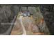 Aerial view of a secluded home with a long driveway surrounded by mature trees, showing property lines at 172 Sam Solomon Rd, Locust Grove, GA 30248
