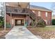 Charming backyard with brick exterior, deck, garage access, and outdoor seating area at 172 Sam Solomon Rd, Locust Grove, GA 30248