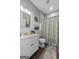 Bathroom featuring wainscoting, patterned shower curtain, vanity, and decorative accents at 172 Sam Solomon Rd, Locust Grove, GA 30248