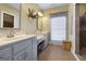 Double sink bathroom with granite countertops, ample storage, and a serene ambiance at 172 Sam Solomon Rd, Locust Grove, GA 30248