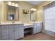 Bathroom with double vanity, decorative mirrors, and plenty of cabinet space at 172 Sam Solomon Rd, Locust Grove, GA 30248