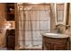 Charming bathroom with unique vanity, rustic decor, and a shower with stylish curtain at 172 Sam Solomon Rd, Locust Grove, GA 30248
