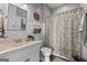 Cozy bathroom featuring wainscoting, patterned shower curtain, vanity, and decorative accents at 172 Sam Solomon Rd, Locust Grove, GA 30248