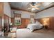 Cozy bedroom featuring wood paneling, two windows, tv and ample natural light at 172 Sam Solomon Rd, Locust Grove, GA 30248