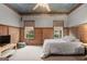 Cozy bedroom with natural light, neutral tones, wood panels, and comfortable furnishings at 172 Sam Solomon Rd, Locust Grove, GA 30248