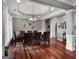 Spacious dining room with hardwood floors, large windows, and elegant décor for formal gatherings at 172 Sam Solomon Rd, Locust Grove, GA 30248