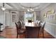 An elegant dining area featuring a large table, leather chairs, and views of the front yard at 172 Sam Solomon Rd, Locust Grove, GA 30248