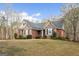 Beautiful home with a brick and stone facade, well-kept lawn, and mature trees at 172 Sam Solomon Rd, Locust Grove, GA 30248