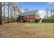 Charming exterior featuring a two-story brick home, complemented by a lush lawn at 172 Sam Solomon Rd, Locust Grove, GA 30248
